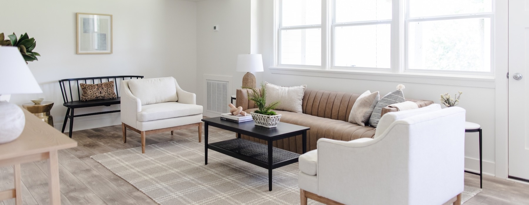 a living room with a couch, chairs and a coffee table